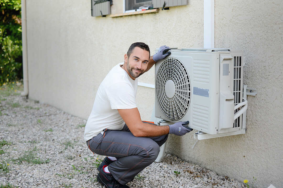 Professional installer checking heat pump running and evaluating costs